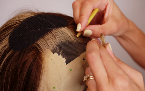 Person ventilating a lace wig hairline